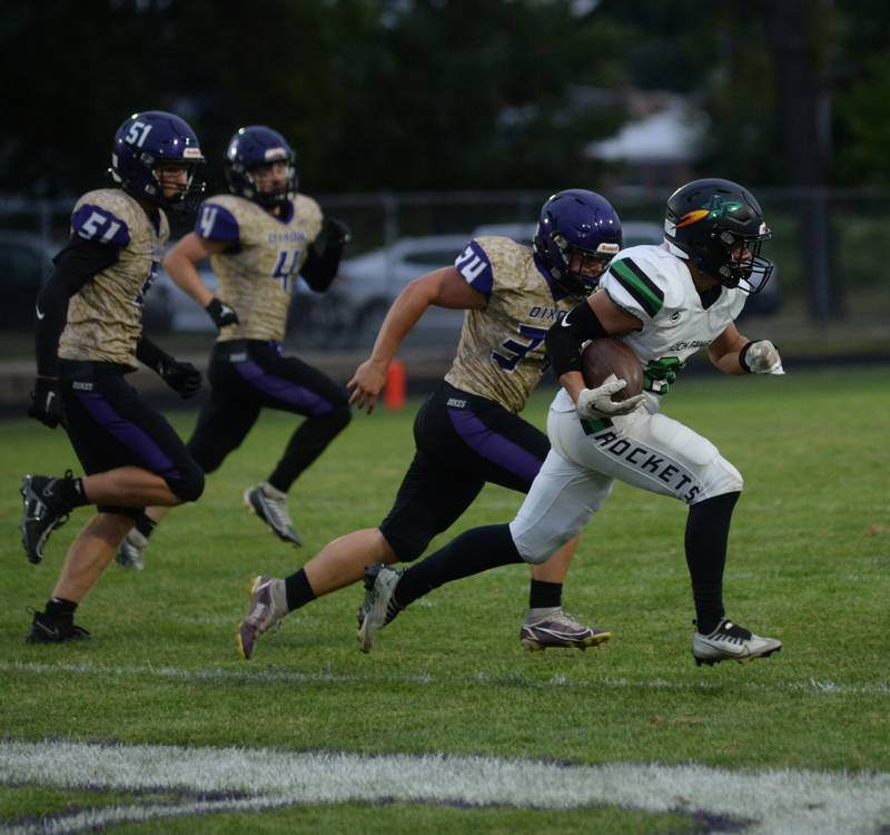 Dixon's Caleb Carlson (34), John Godbold (51) and Easton Roux (4) chase Rock Falls' Korbin Oligey (26) on the opening kick off at AC Bowers Field in their season opener against Rock Falls on Friday, Sept. 9, 2023.