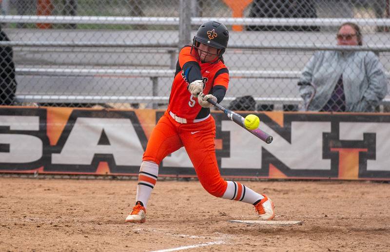 St. Charles East's Nikki Johnston (5) makes contact on a pitch against St. Charles North during a softball game at St. Charles East High School on Monday, April 25, 2022.