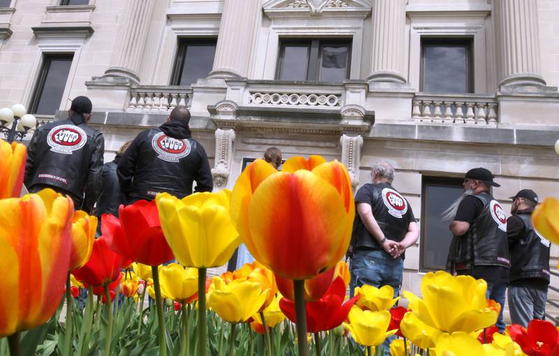Members of the Fox Valley Illinois chapter of Bikers Against Child Abuse listen to speakers Tuesday, April 16, 2024, during the Hands Around the Courthouse event at the DeKalb County Courthouse in Sycamore. The event, hosted by CASA DeKalb County and Family Service Agency of DeKalb County, was held in honor of National Child Abuse Prevention Month.