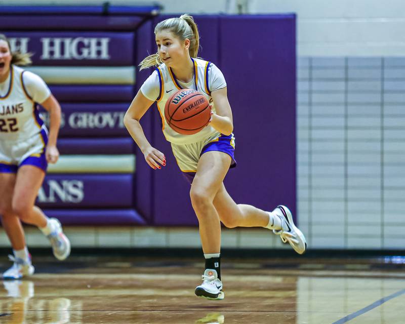 Downers Grove North's Abby Gross (11) advances the ball during girls basketball game between Downers Grove South at Downers Grove North. Dec 16, 2023.