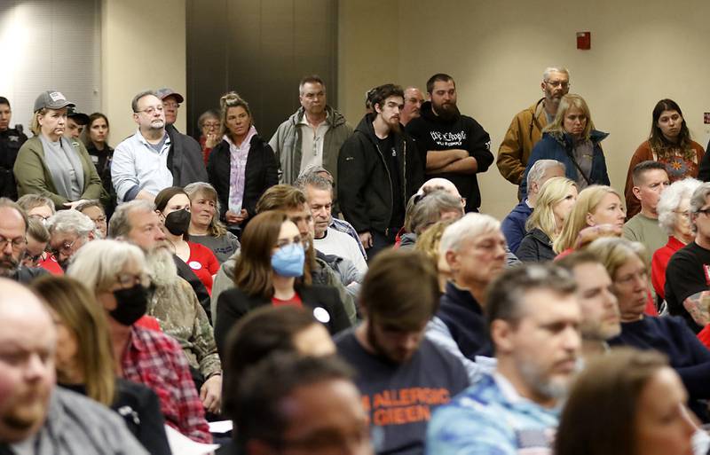 People listen to speakers Tuesday, Feb. 21, 2023, during the public comment period at the McHenry County Board meeting about the proposed resolution opposing the Illinois gun ban and supporting its repeal in the Illinois State Legislature.