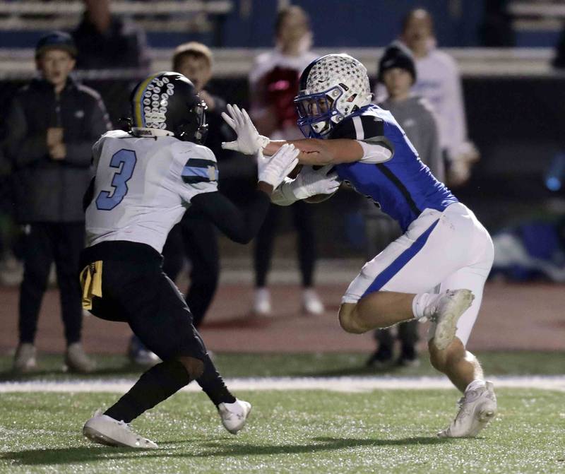 St. Charles North's Drew Surges (6) cuts back past Maine West’s Isaac Pittman (3) Friday October 28, 2022 in St. Charles.