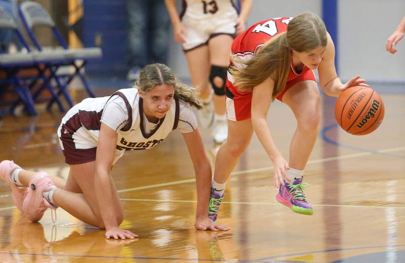 Hall's Leah Pelka picks up a loose ball from Illinois Valley Central's Rianna Foster during the Princeton Holiday Girls Basketball Tournament on Tuesday, Nov. 19, 2024 at Princeton High School.
