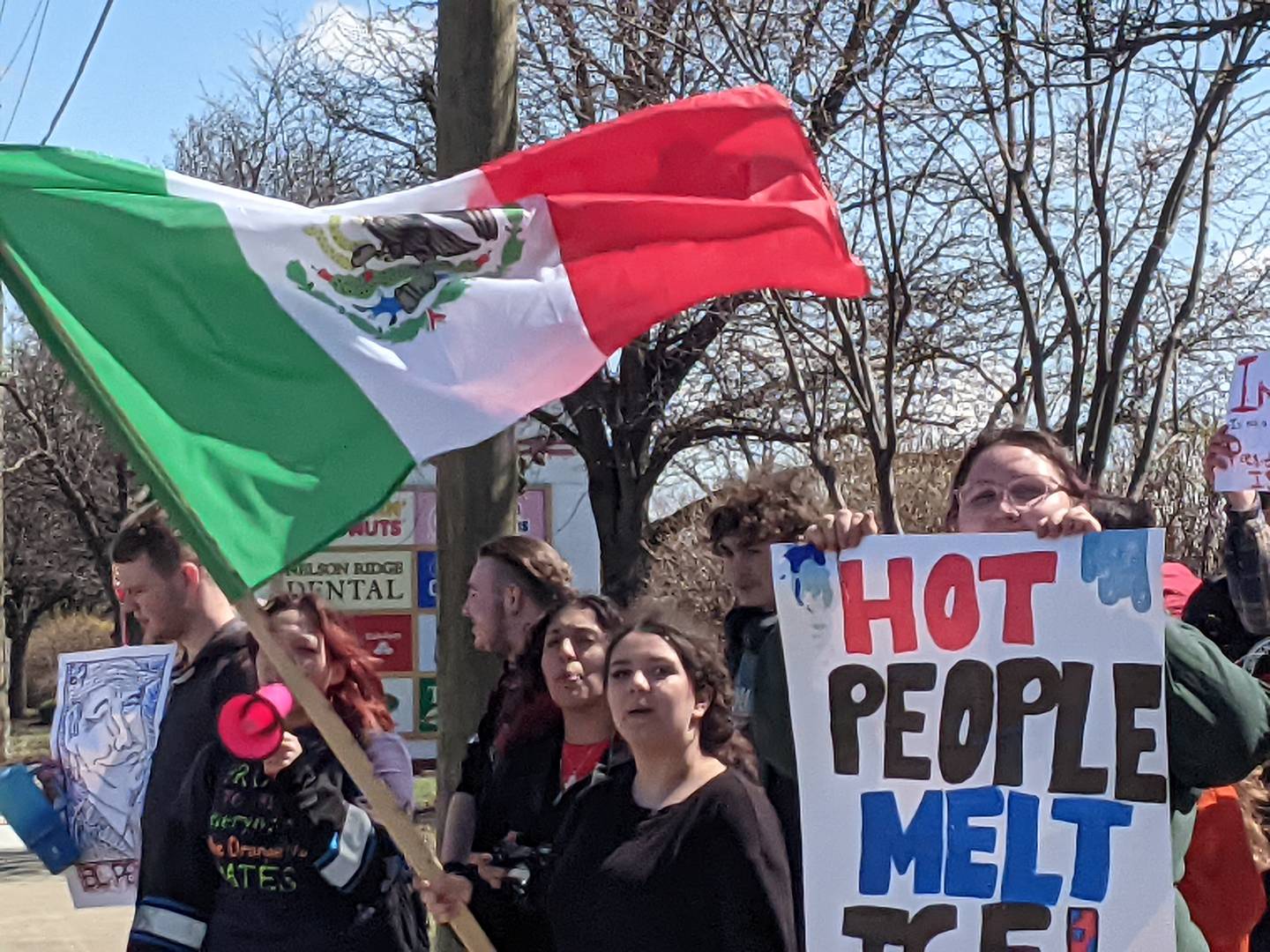 A group of Lincoln-Way West High School participate in a protest against the actions of ICE agents near the intersection of Nelson and Laraway roads in New Lenox on Friday, March 27, 2026.