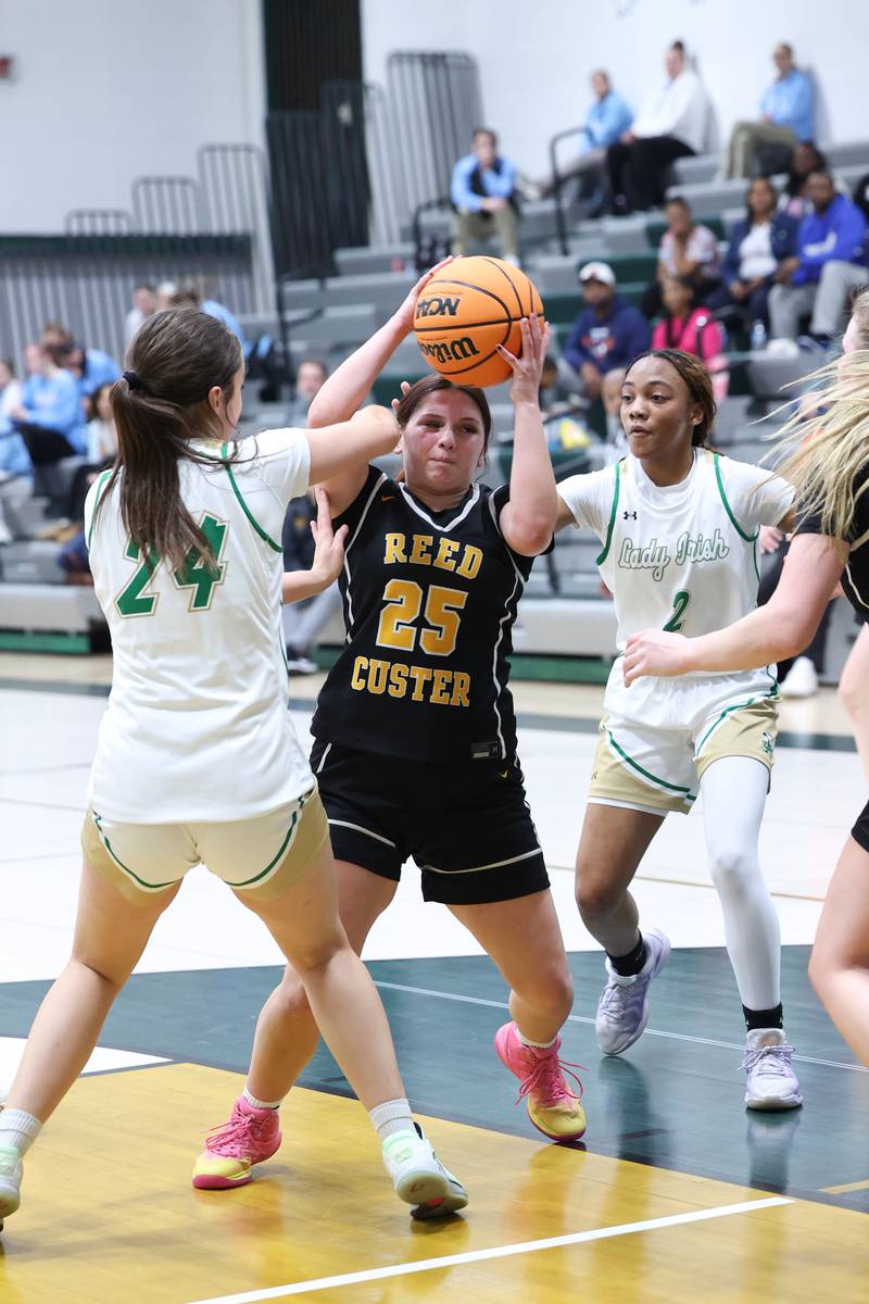 Reed-Custer's Brooklyn Gonzalez is swarmed by Bishop McNamara defenders during Bishop McNamara's 60-36 victory over Reed-Custer in the IHSA Class 2A Bishop McNamara Regional semifinals on Monday, Feb. 16, 2026.