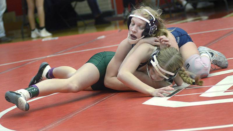 Marquette’s Lily Deibel controls her Peoria Richwoods opponent Tuesday, Dec. 30, 2025, during the semifinals of the Ottawa Holiday Hootenanny in Kingman and Love gyms.