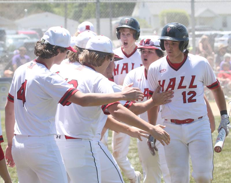 Hall's Kyler Lapp (right) hi-fives his teammates after hitting a home run during the Class 2A Sectional final game on Saturday, May 27, 2023 at Knoxville High School.