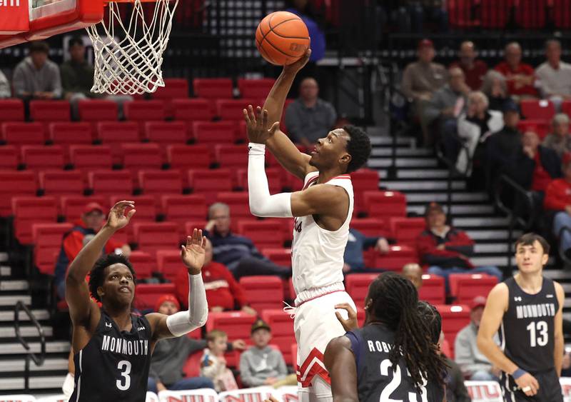Northern Illinois' Joe Munden Jr. drives the lane against Monmouth's Madison Durr during their game Tuesday, Nov. 12, 2024, in the Convocation Center at NIU in DeKalb.