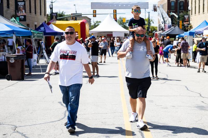 C.J. Nelson and Patrick Maier – along with Patrick's son Bowen – enjoy Fire Fest, held in Lockport's Historic District, on August 10, 2024.
