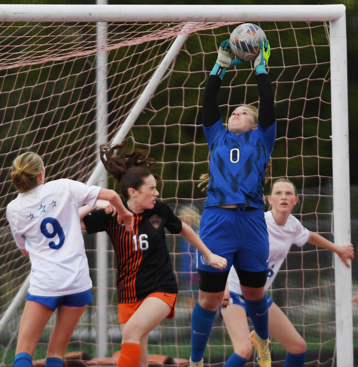 St. Charles North goal keeper Lauren Korioth pulls down the ball from a corner kick as teammate Keira Connolly, left, and St. Charles East’s Averie Foulkes make contact in front of the net during Tri-Cities soccer night on Tuesday, May 5, 2026 in Batavia.