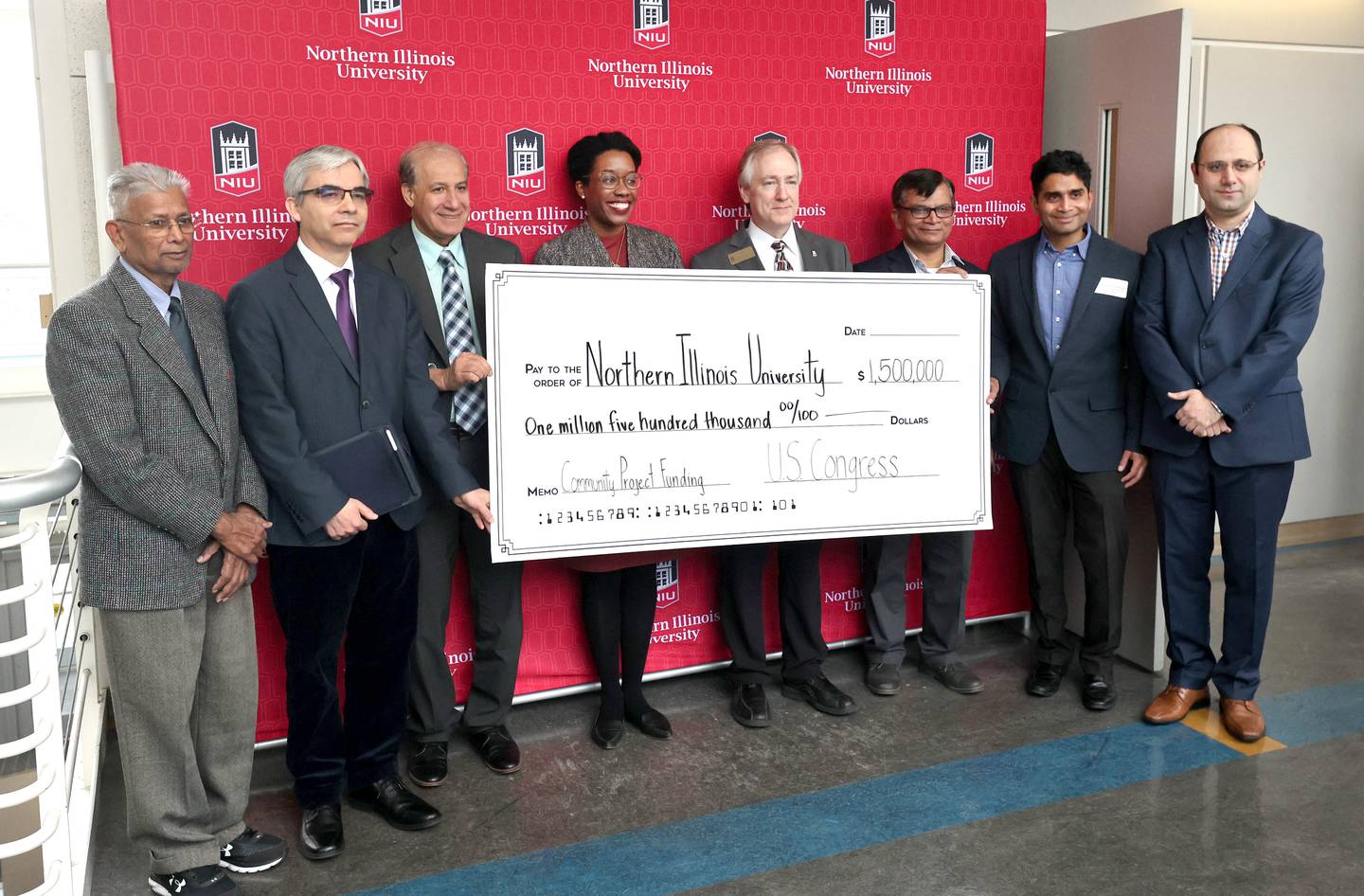 U.S. Rep. Lauren Underwood, D-Naperville, along with Northern Illinois University faculty from the College of Engineering and Engineering Technology hold a check Friday, Jan. 20, 2023, for $1.5 million in federal funding to upgrade the NIU microchips manufacturing lab.