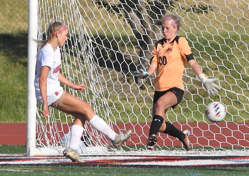 Barrington’s Brooke Brown gets a rebound goal against Libertyville’s Kaate Hopma in the IHSA girls state soccer semifinal game at North Central College in Naperville on Friday, June 2, 2023.