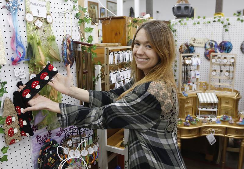 Candace Utley of Temperance Crystals shows of an item for sale in the “Fairy Shop” booth at Q'Tiques in McHenry on Wednesday, May 22, 2024.
