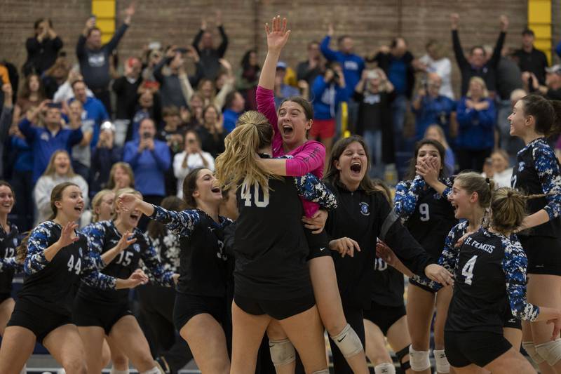 St. Francis’ Jessica Schmidt hoists the 3A supersectional plaque high after the Spartans defeated Metamora Friday, Nov. 4, 2022 in Sterling.