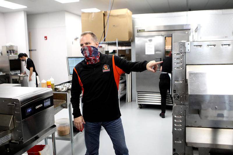 Lance Bell, owner of AJ Sliders in St. Charles, shows some of the kitchen equipment they use to make their namesake sliders. The restaurant is now open for carryout and delivery at 2075  Prairie St., Suite 110 in St. Charles.