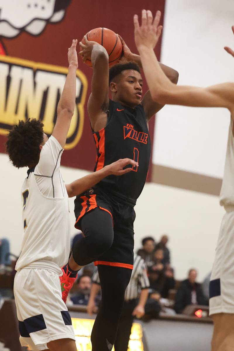 Romeoville’s Mickeis Johnson looks to pass against Lemont in the WJOL Thanksgiving Classic Championship in Joliet on Saturday.