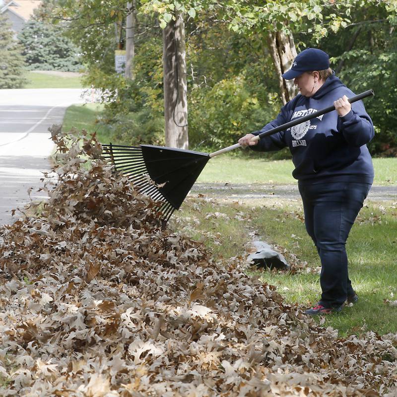 Brenda Kowalski rakes leaves Monday, Oct. 9, 2023, in McHenry. Many municipalities are just starting to pick up leaves.