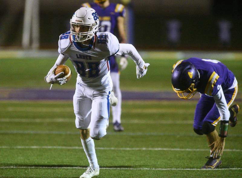 Lakes' Elijah Carbonell-Reid (88) makes a catch and runs into the endzone for a first-half touchdown against Wauconda during Friday’s football game in Wauconda.