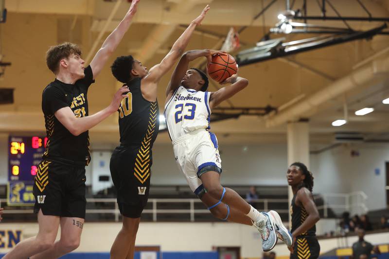Joliet Central’s Danny Thompson finesses a shot against Joliet West on Saturday, Jan. 27th, 2024 in Joliet.