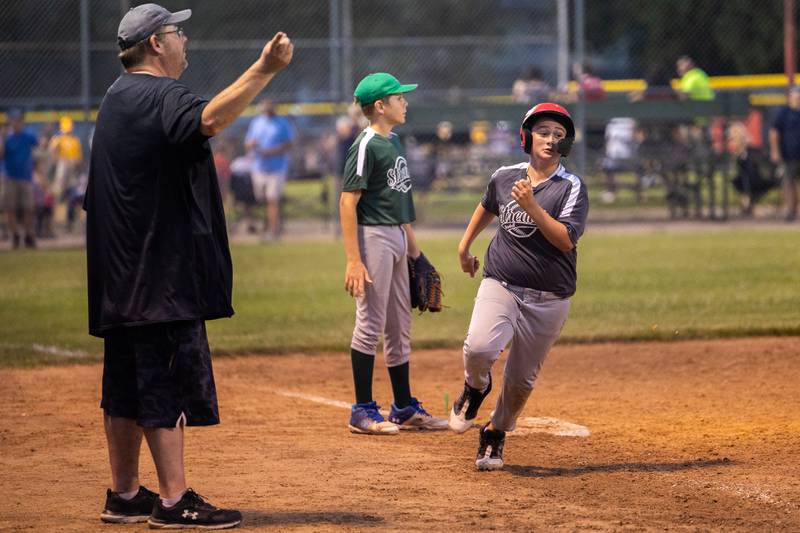 Elliott Volkman (9) of Winterrowd Funeral runs home as coach Mike Volkman waves him onward Wednesday, June 25, 2025, at Southside Park in Streator.