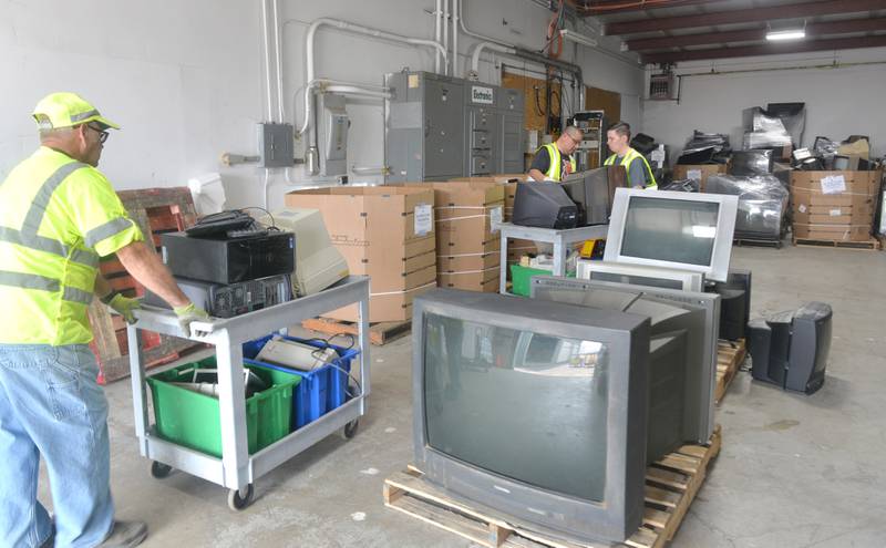 Volunteers stack television and other items during the electronics recycling event conducted by the Ogle County Solid Waste Management Department on Friday, June 23. The residential recycling program is for Ogle County residents only and requires a free permit before dropping items off. The next recycling event is July 28.