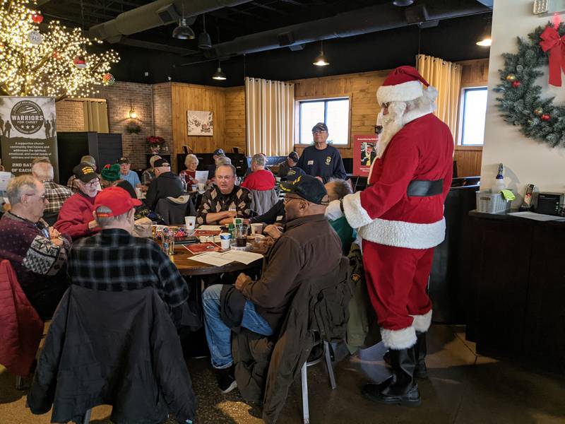 Santa Claus visits with those attending the Fox Valley Veterans Breakfast Club's holiday celebration at 113 Main restaurant in downtown Oswego on Thursday, Dec. 11, 2025.