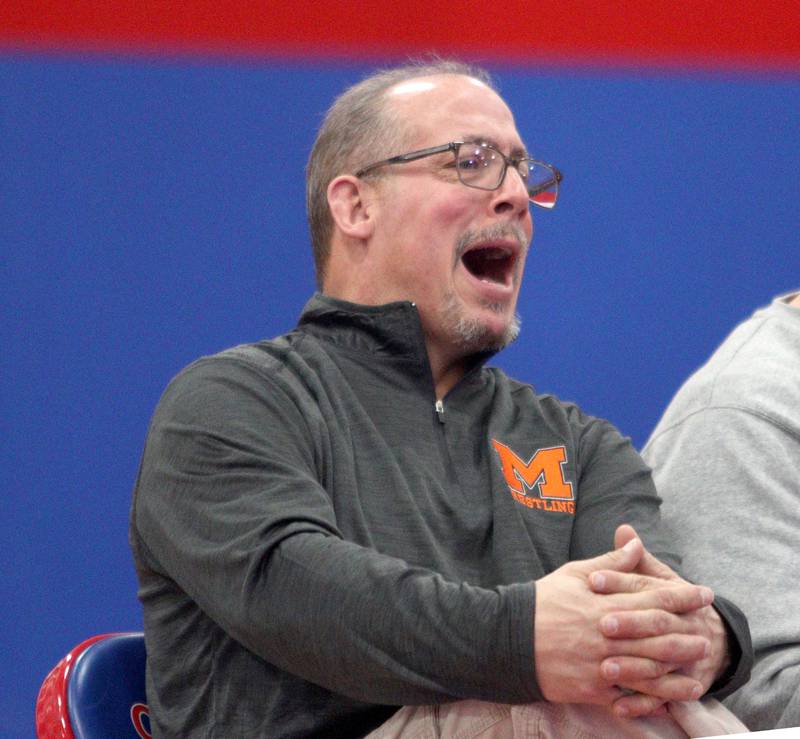 McHenry’s Head Coach Dan Rohman guides the Warriors in varsity wrestling at Carpentersville Thursday night.