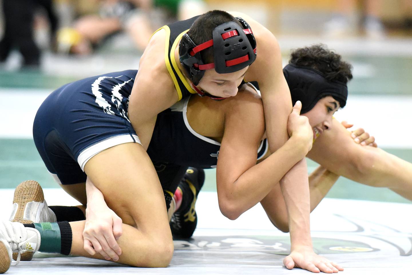 Reed-Custer's Colton Drinkwine, left, gets position atop Hope Academy's Indigo Berg during the 106-pound championship match at the IHSA Class 1A Coal City Sectional Saturday, Feb. 15, 2025.