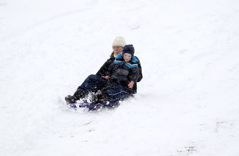 Sarah Passman of Batavia and her 2-year-old son, Thomas, sled down the hill at Fabyan Forest Preserve in Geneva on Wednesday, Jan. 25, 2023.