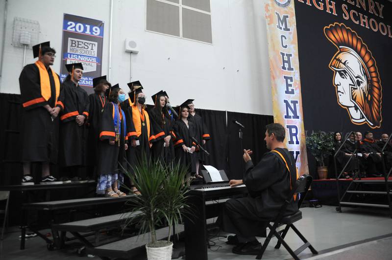 Senior members of the Vocal Department sign “Rivers and Roads” Saturday, May 21, 2022, during the McHenry High School’s 102nd Commencement Ceremony in the gym of the school’s Upper Campus. The ceremony was moved inside and split into two ceremonies because of the rainy weather.