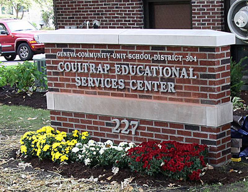 District 304 Superintendent Dr. Kent Mutchler points to the new sign during Saturday's dedication ceremony for the Coultrap Educational Services Center. At right is Paul Coultrap, grandson of Harry Coultrap.