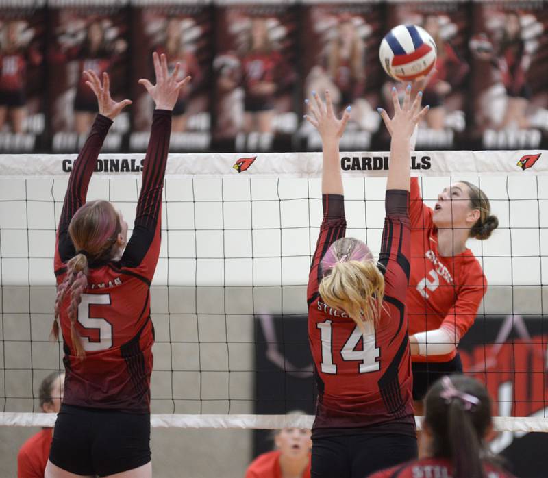 Oregon's Grace Tremble (2) spikes as Stillman Valley's Aleigha Hodge (5) and Ava Janssen (14) go up to block during a Big Northern Conference contest on Thursday, Oct. 17, 2024 at Stillman Valley. The Hawks won the contest in three sets.