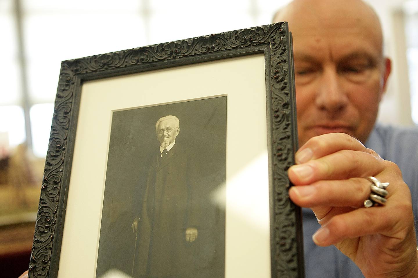 Historian Steve Bigolin holds a photograph of Jacob Haish taken in 1915 at the DeKalb Senior Center on Grove Street in DeKalb on Monday, July 7, 2014.  Bigolin received the photo from Shirley Nehring while he was helping her sort boxes from the bank building at Second Street and Lincoln Highway, formerly the DeKalb Chamber of Commerce office, after her husband Paul M. Nehring died in 1999. Haish was 89 years old in this photograph and died on Feb. 19, 1926, just shy of his 100th birthday.