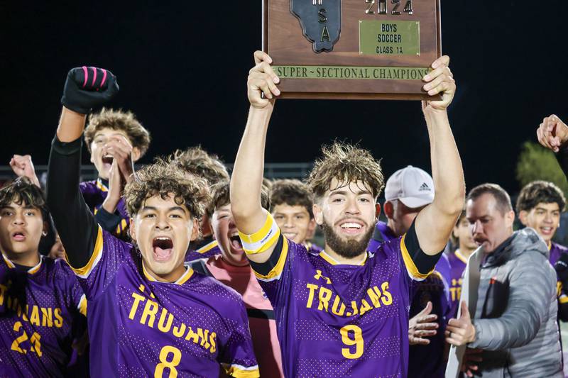 Players of Mendota celebrate win over Aurora Central Catholic High School with plaque on Saturday, November 2, 2024 at Richard E. Phalen, SR. Field in Mendota.