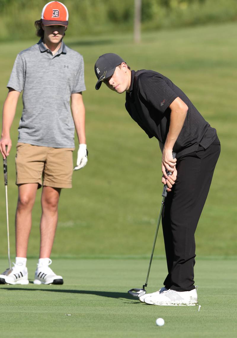 DeKalb's Daniel Rowan Jr. putts on the 4th green as TJ Fontana watches his line Tuesday, Aug. 9, 2022, during golf practice at River Heights Golf Course in DeKalb.