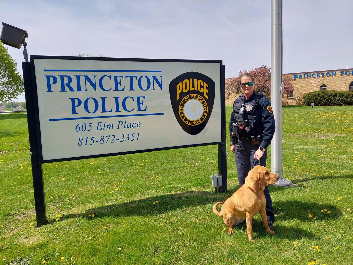 Princeton police officer Sara Rokey poses with her bloodhound and K9 officer Lucy.