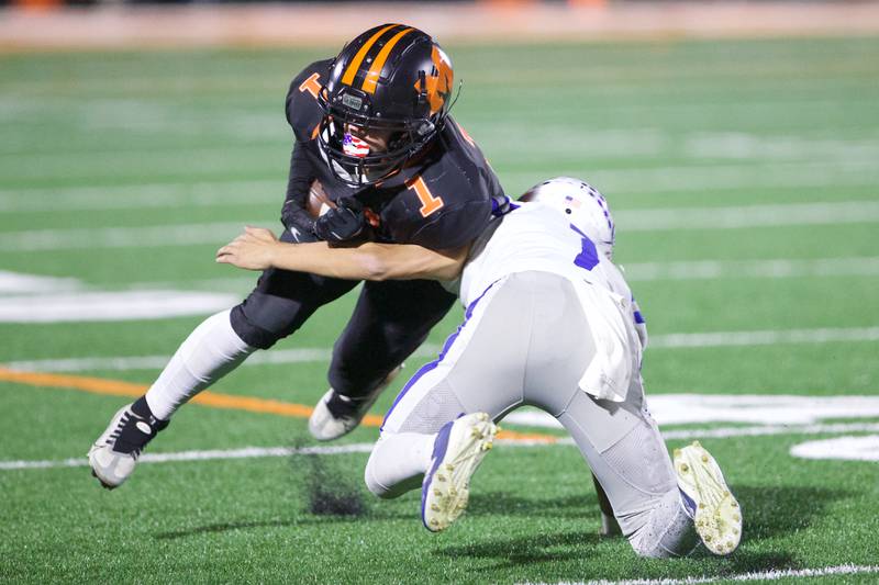 McHenry's Jacob Zarek is tackled by Burlington Central's Ryder Bergmann 
on Friday, Oct. 21,2022 in McHenry.