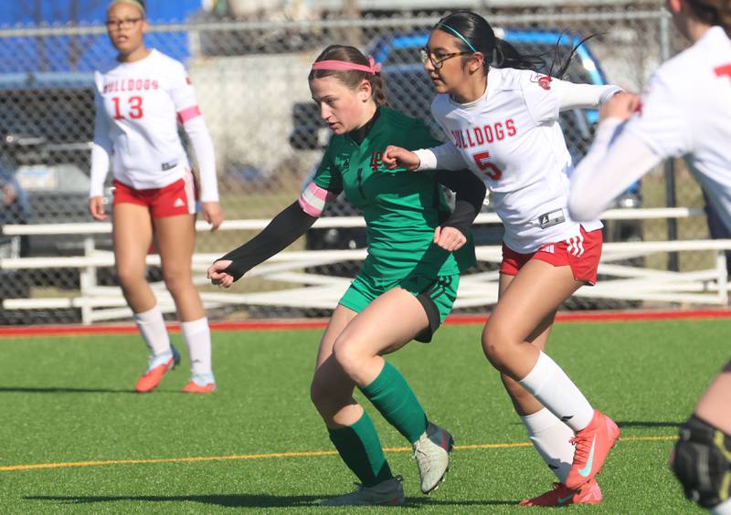 L-P's Addie Dawson chases down the ball with Streator's Yareli Garcia on Friday, March 27, 2026 at the L-P athletic complex in La Salle.