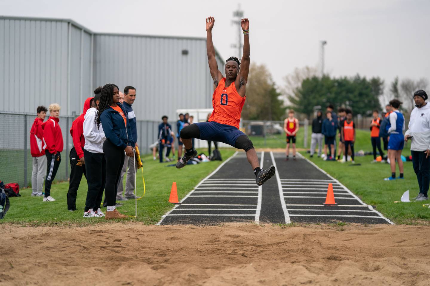 Oswego’s Caleb Wright competes in the long jump during the Roger Wilcox Track and Field Invitational at Oswego High School on Friday, April 29, 2022.