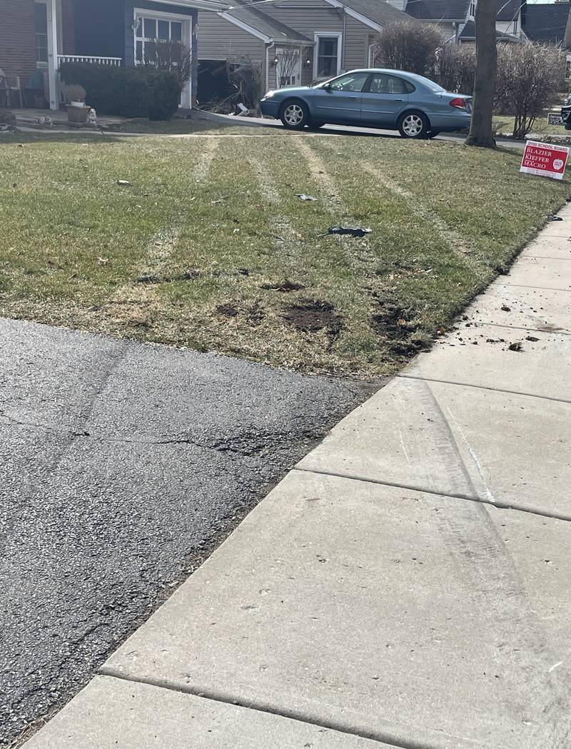 Tire marks left by the vehicle that crashed into the Crystal Lake home of Danielle Irwin on Monday, March 20, 2023, causing damage to her garage, car and belongings.