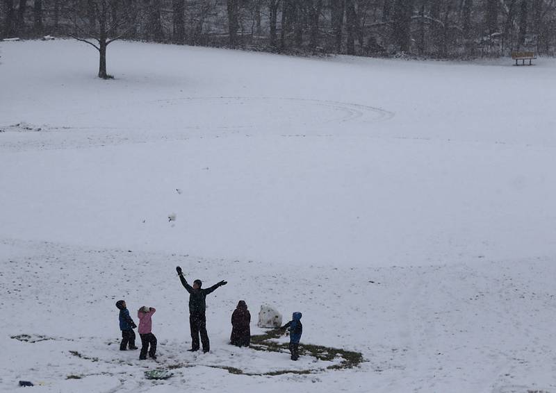 Members of the Anderson family, of Crystal Lake, toss snow into the air as they build a snowman in Veterans Acres Park as a winter storm moves through McHenry County on Tuesday, Jan. 9, 2024, delivering snow to most of the county. I like this photograph because of the fun that is showing in the photograph as the family enjoys the first snow fall of the year.