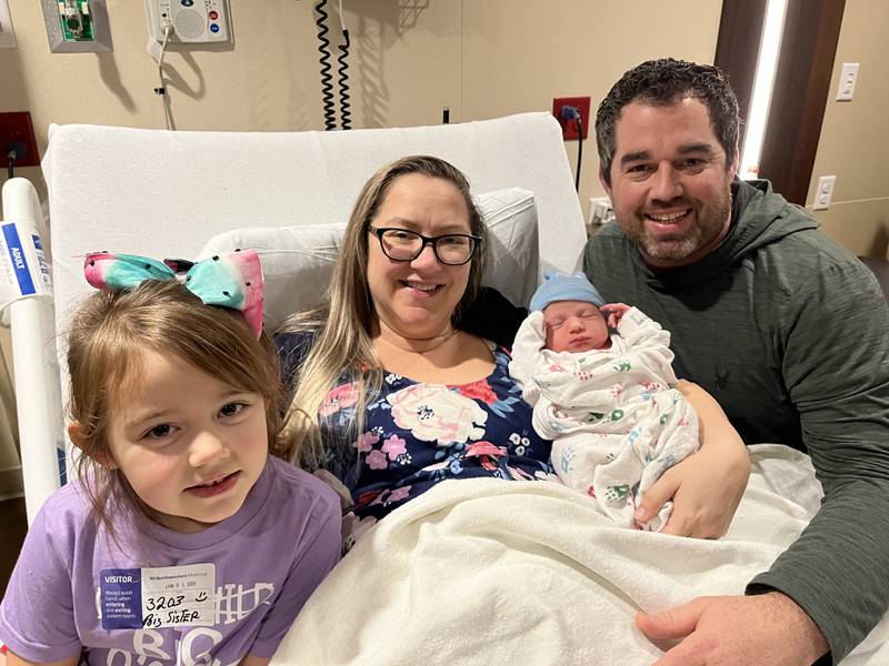 Theodore, center, joins sister Annabelle, left, and parents Heather and John Barnes as the first baby born at Northwestern Medicine Huntley Hospital on Monday, Jan. 1, 2023.