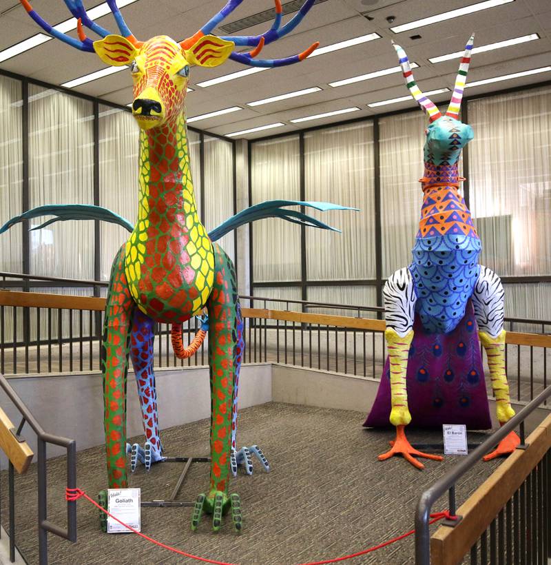 Two of the alebrijes, Goliath, (left) by Edgar Israel Camargo Reyes, and El Baron, by Alberto Moreno Fenandez, Thursday, Feb. 29, 2024, in Founders Memorial Library at Northern Illinois University in DeKalb.