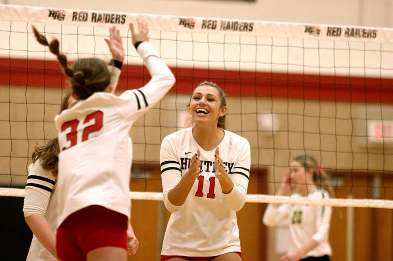Huntley’s Avery Gonzalez and the Red Raiders celebrate a point in their two-set win over Crystal Lake South in varsity volleyball at Huntley Tuesday.