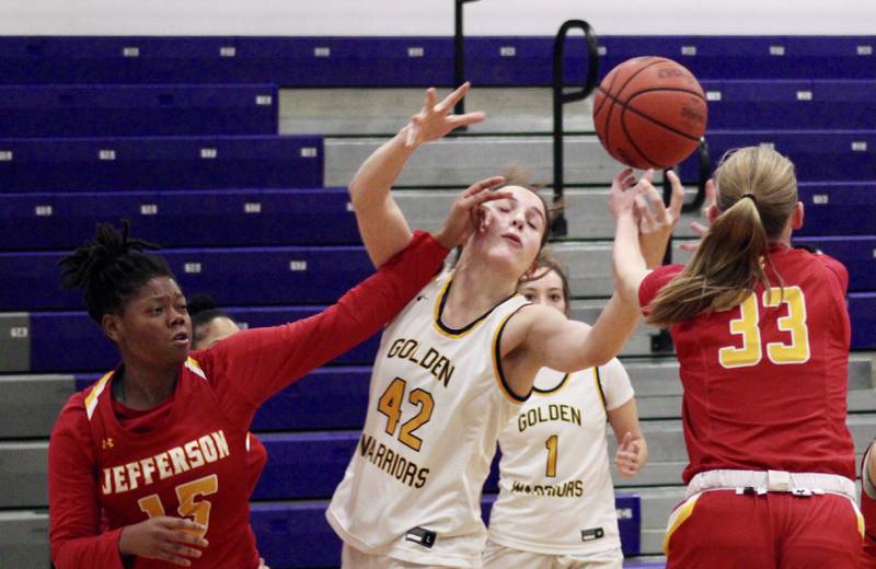 Rockford Jefferson's Kaidence Bailey (15) brushes the face of Sterling's Madison Austin (42) while she and Jefferson's Abigail Bracius (33) reach for a rebound on Wednesday at Dixon KSB Holiday Classic. Jefferson won 41-37.