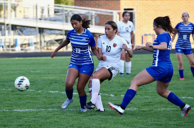 L-P senior Litzy Lopez takes a shot between Princeton's Ava Hobson and Miyah Fox Tuesday night at Bryant Field in Princeton. The Cavs won 6-1.