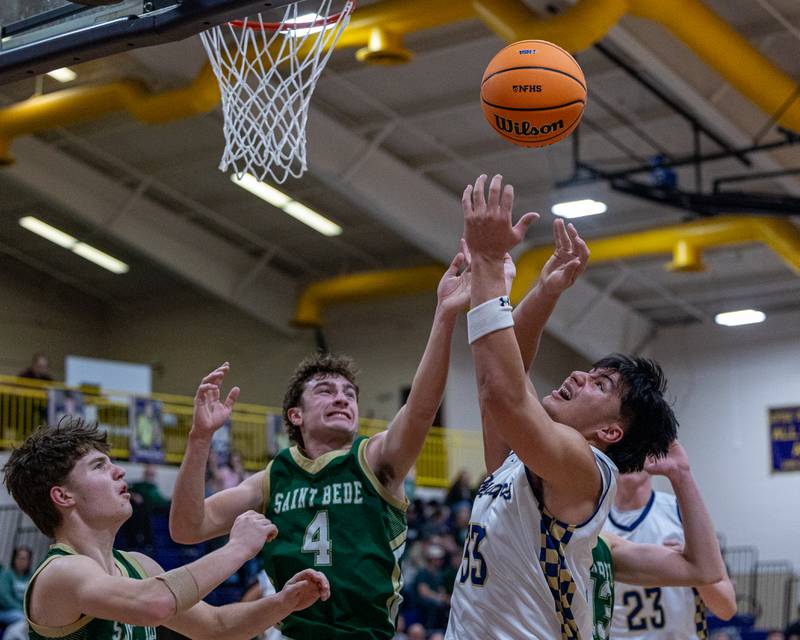Marquette's Blayden Cassel (33) and St. Bede's Gino Ferrari (4) reach for rebound during the Class 1A Regional Boys Basketball Championship game on Friday, Feb. 27, 2026 at Serena High School.