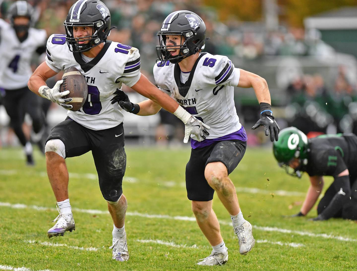 Downers Grove North’s Oliver Thulin intercepts a Glenbard West pass for a pick six touchdown as he’s escorted by teammate Maxwell Troha (5) during a Class 7A second-round playoff game on November 8, 2025 at Glenbard West High School in Glen Ellyn.