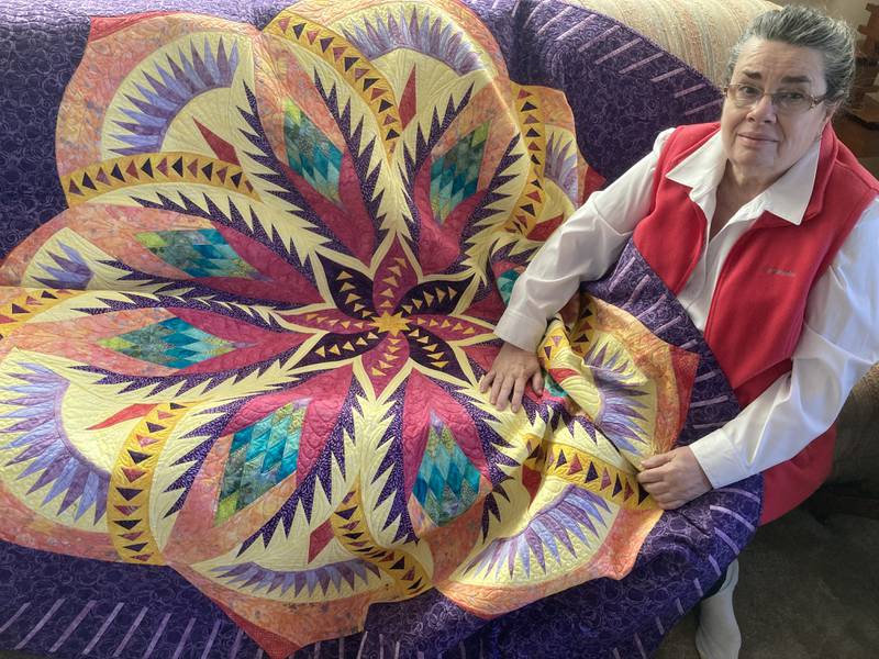 Retired Streator teacher Pam Riss displays her quilt Vintage Rose. It will be one of 13 other quilts on display during the Peoria Riverfront Museum's exhibit featuring Ken Burns' personal collection.
