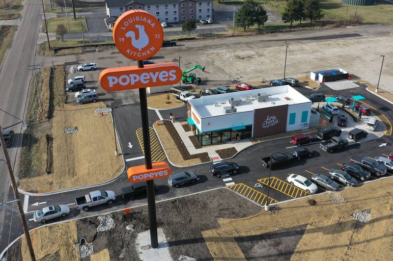 A long line of vehicles is backed up onto May Road for the opening of Popeyes on Monday, Dec. 9, 2024. The franchise opened their doors on Friday.